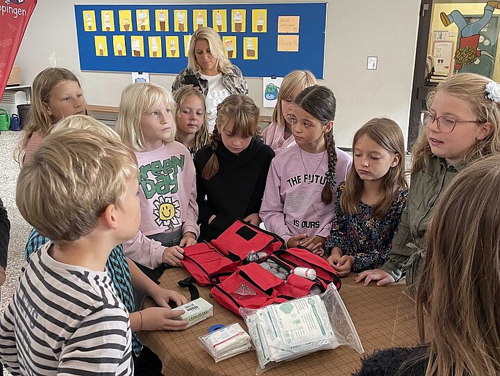 Juniorhelfer der Grundschule im Rot begutachten ihren neuen Erste-Hilfe-Rucksack